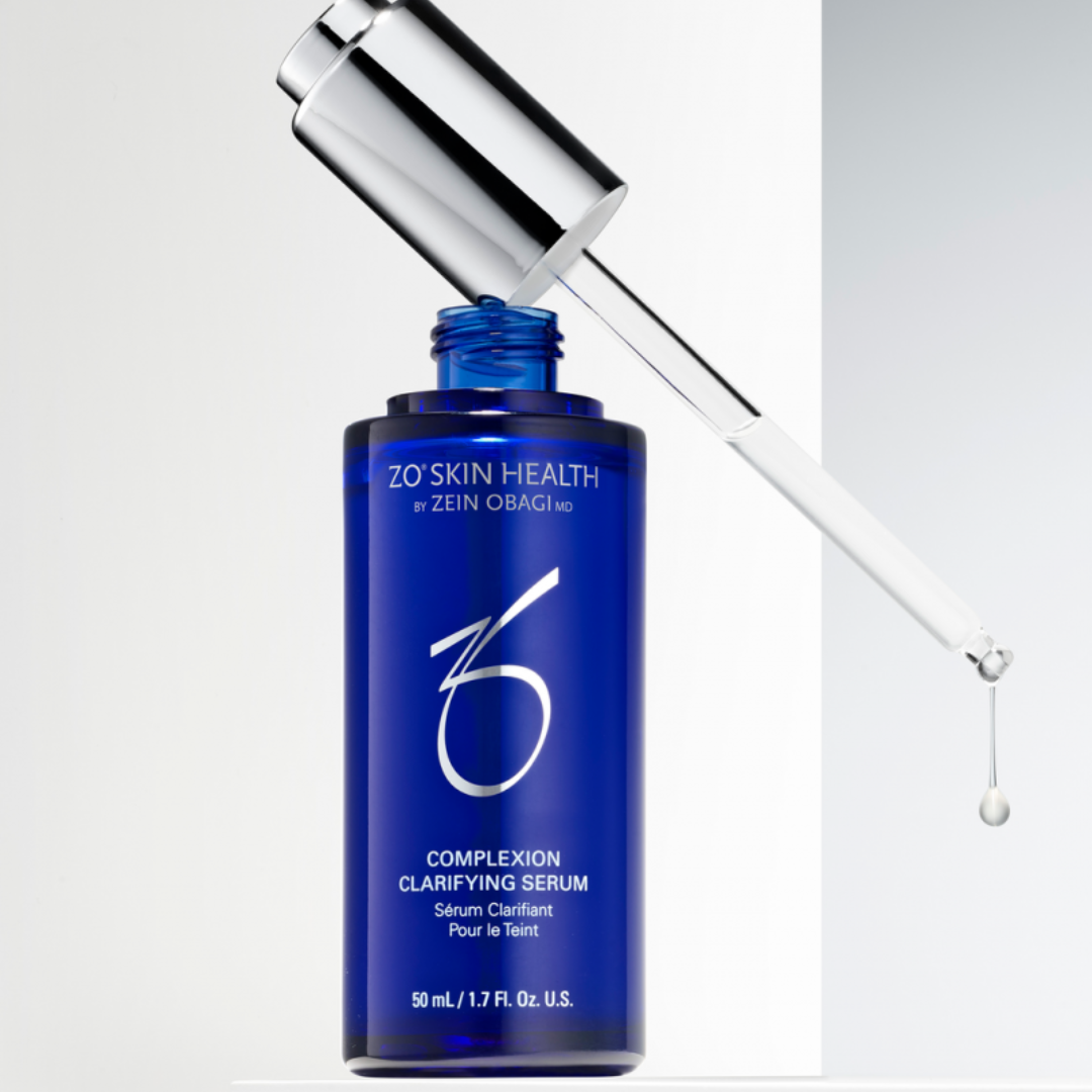 Blue bottle of ZO Skin Health Complexion Clarifying Serum with dropper releasing serum drop