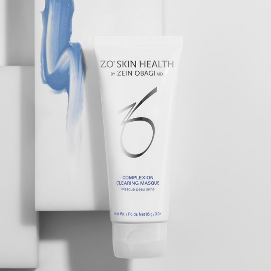 ZO Skin Health Complexion Clearing Masque tube on white surface with blue cosmetic cream smear