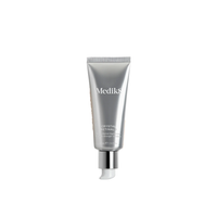 Medik8 Crystal Retinal 5 anti-ageing night serum in silver tube, isolated on white background
