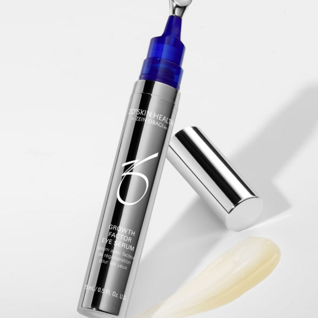 ZO Skin Health Growth Factor Eye Serum in metallic bottle with blue applicator and cream smear