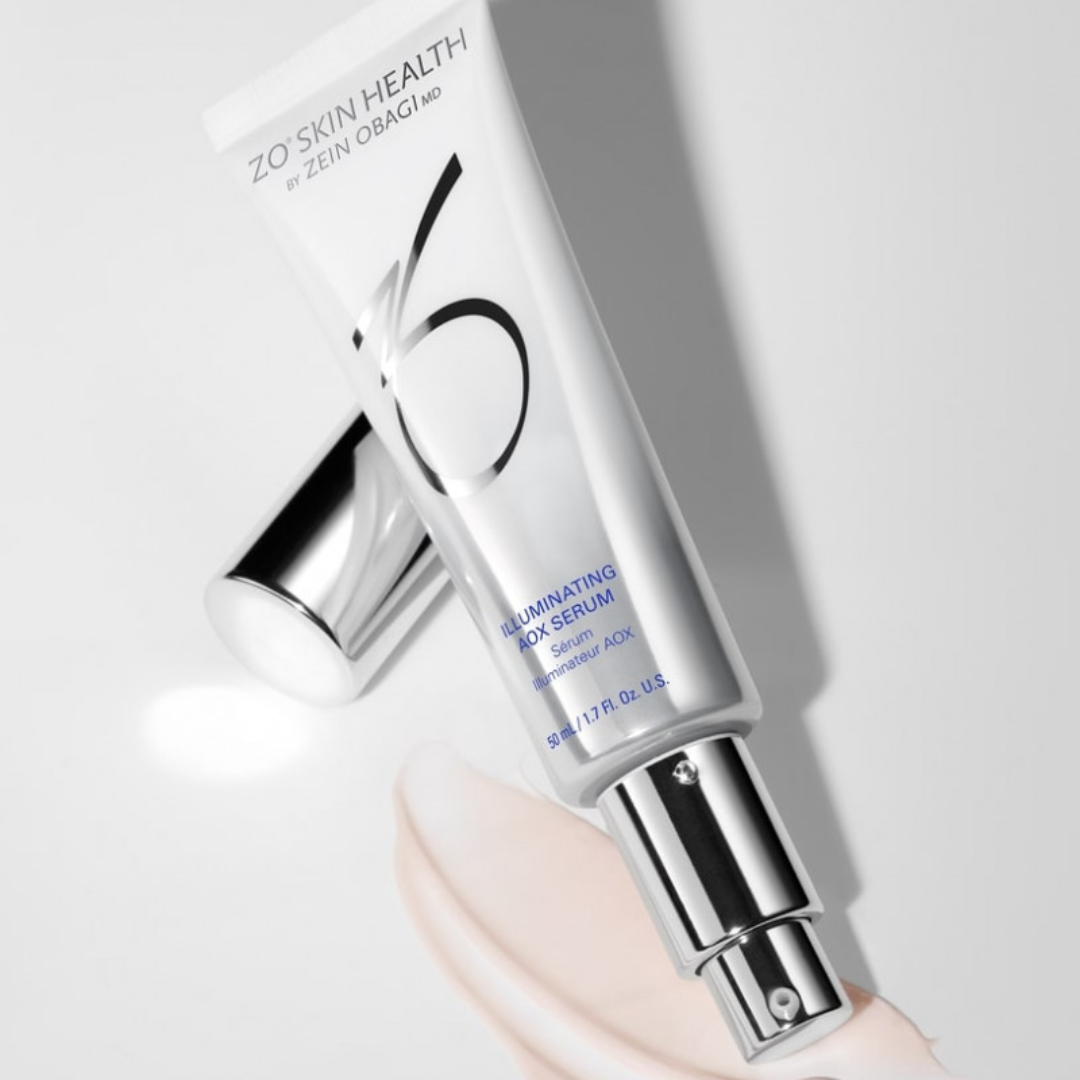 ZO Skin Health Illuminating AOX Serum tube with silver cap on white surface with serum smear