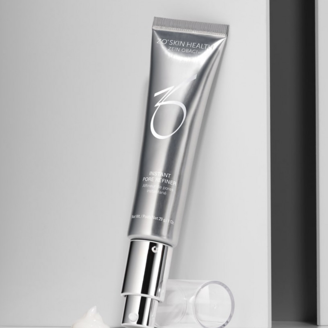 Silver tube of ZO Skin Health Instant Pore Refiner with pump and cream on white surface