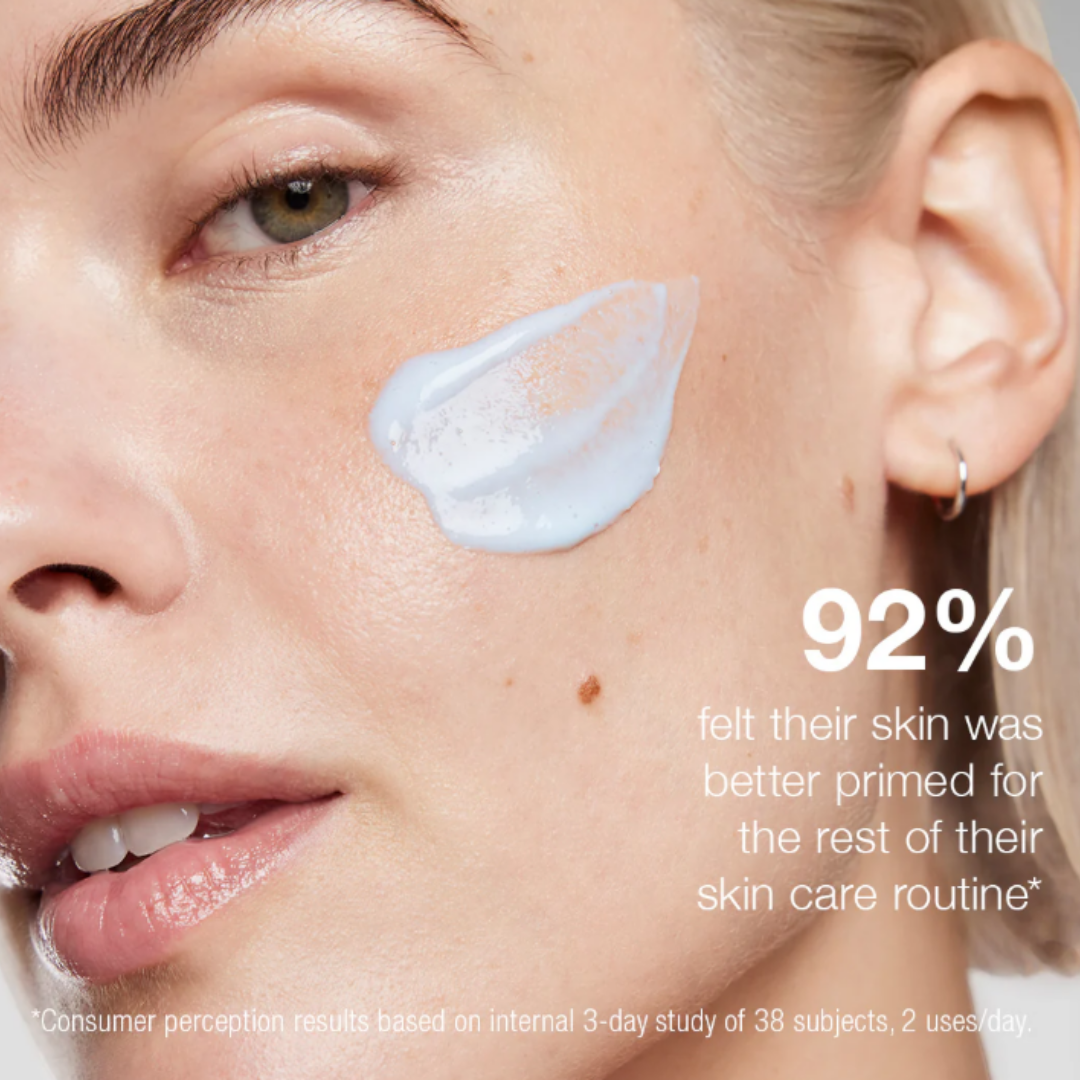 Close-up of woman with skincare cream applied on cheek showing hydrated, smooth skin texture